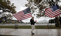 Ed Houck and others carry American flags along Abbott Rd in front of New Era Field to draw attention in support for the flag and for respect of the National Anthem Friday, Sept. 29, 2017. (Mark Mulville/Buffalo News)