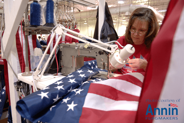 An Annin employee sewing American flags