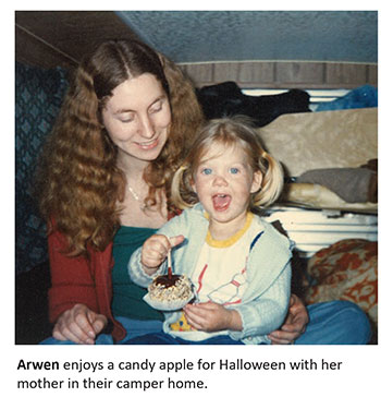 Arwen enjoys a candy apply for Halloween with her mother in their camper home