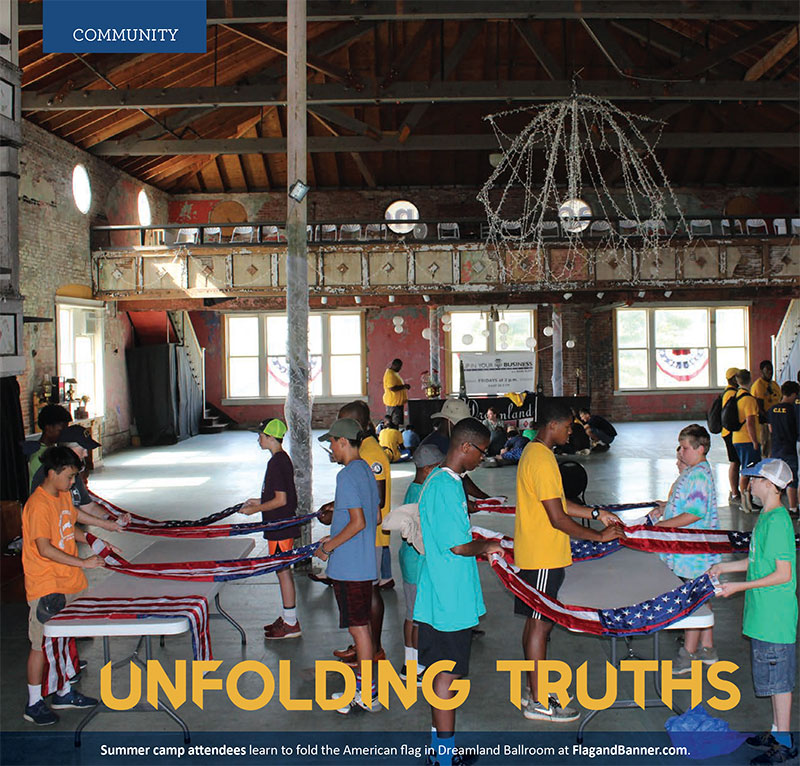 Summer camp attendees learn to fold the American flag in Dreamland Ballroom