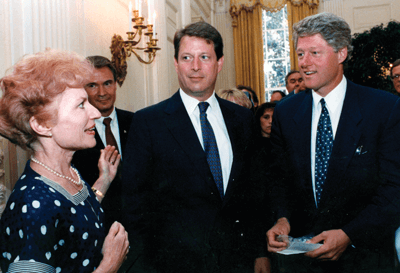 Ann McCoy discusses event details with President Clinton and Vice President Al Gore