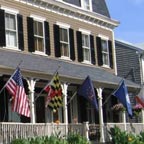 Multiple flags displayed on front porch