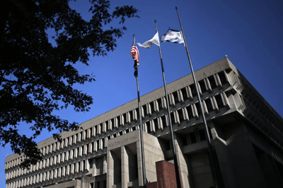 Flags fly above Boston City Hall on Nov. 11.Lane Turner / Boston Globe via Getty Images file