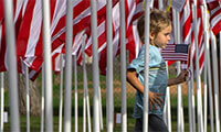 Patrick Keller, 5, of Orange runs through a maze of flags during opening ceremonies for the Field of Valor in Orange on Sunday, November 5, 2017.(Photo by Mindy Schauer, Orange County Register/SCNG)