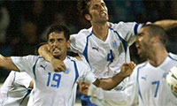 In this Match 26, 2005 file photo, Israel's Abas Suan , left, and Arik Benado , center, celebrate after Suan scored during the World Cup qualifying soccer match against Ireland in Ramat Gan stadium in Tel Aviv, Israel. President Trump’s clash with professional football players who knelt during the Star Spangled Banner last weekend in September, 2017 has set off a heated debate over etiquette during the national anthem, but the U.S. is not alone. (AP Photo/Ariel Schalit, File)