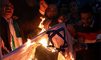 People shout slogans against Israel while burning a makeshift Israeli flag during a protest against Trump's Jerusalem declaration, in front of the Syndicate of Journalists in Cairo, Egypt December 7, 2017. . (photo credit: MOHAMED ABD EL GHANY/REUTERS)