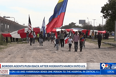 Migrants carrying large American flag try to cross border (KTSM)