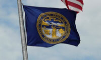 Nebraska's state flag, billowing beneath the U.S. flag. Overduebook/Flickr 