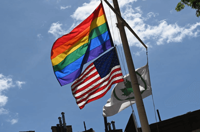 A rainbow flag and an American flag are seen at the Stonewall National Monument, the first LGBTQ national monument, on June 4 in New York City. / Angela Weiss/Getty Images