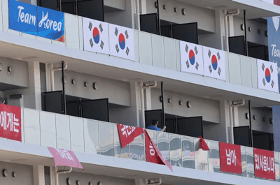 Controversial flags displayed from the balconies of South Korean athletes’ rooms in the Athletes Village. AP