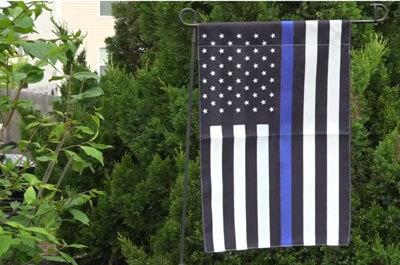 Almost a dozen people living in the Cumberland Crossing neighborhood have put up police flags since last week. (WBNS 10)