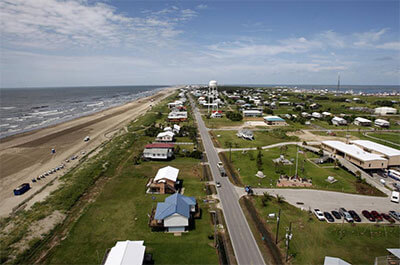 Louisiana State Highway 1 is seen from a Blackhawk helicopter above Grand Isle, La., on July 27, 2010. According to a federal lawsuit filed Tuesday, Jan. 24, 2023, the Louisiana resort town of Grand Isle is trying to suppress free speech with an ordinance aimed at stopping a contractor from flying flags emblazoned with vulgar insults aimed at President Joe Biden and his supporters. (AP Photo/Patrick Semansky, File)