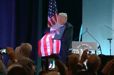 President Trump concluded a speech to the National Federation of Independent Businesses on June 19 by embracing one of the U.S. flags on the stage. (Reuters)