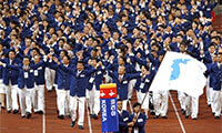 In this Sept. 29, 2002 file photo, athletes from North and South Korea march together, led by a unification flag, during an opening ceremony for the 14th Asian Games in Busan, South Korea. The two sides will do the same at the upcoming Winter Games.  (THE ASSOCIATED PRESS) 