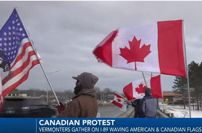 Vermonters waving American and Canadian flags