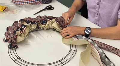 Gray making a ribbon wreath